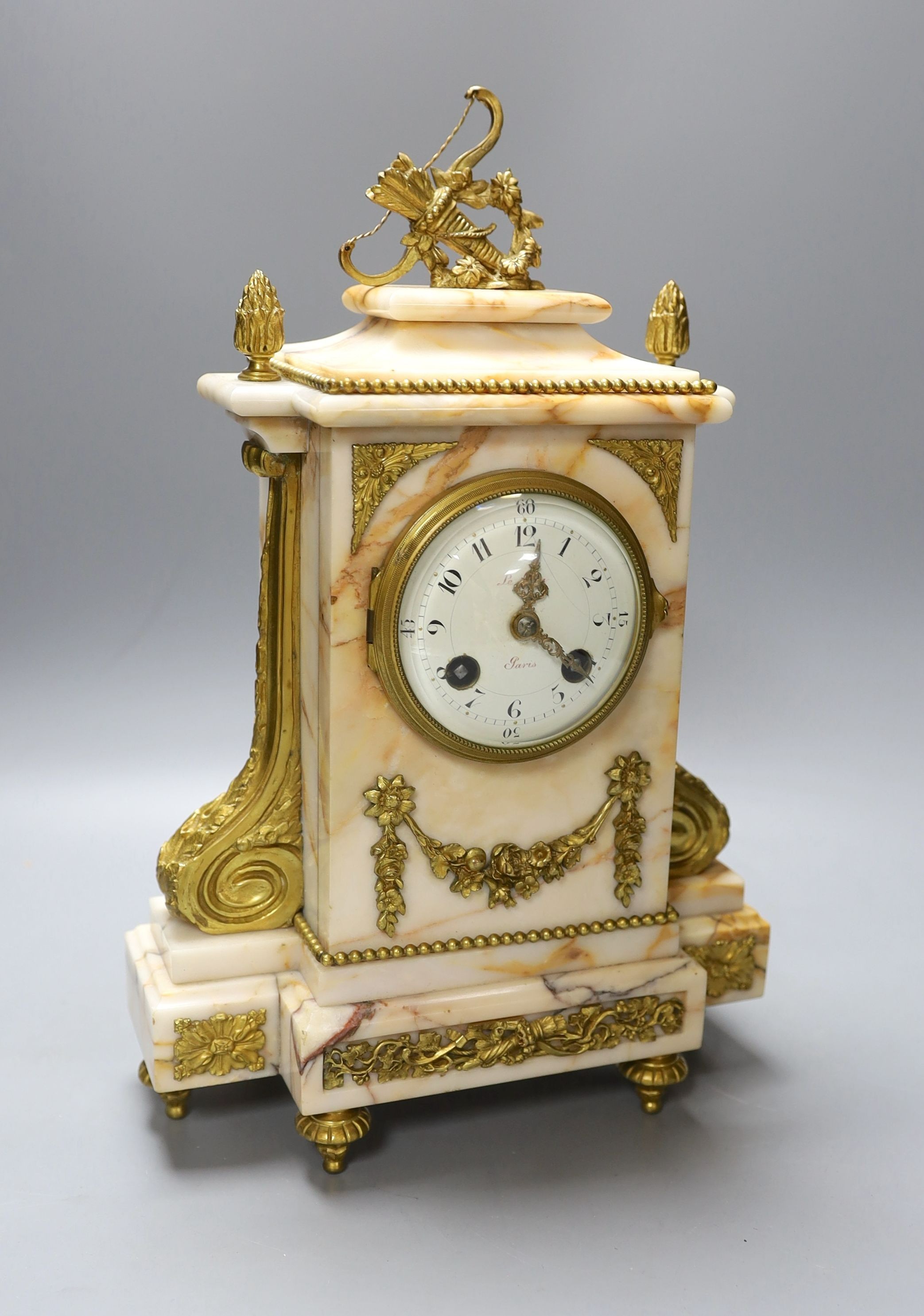 An early 20th century French gilt metal mounted marble clock with pendulum and key 35cm